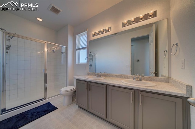 bathroom with vanity, toilet, and walk in shower