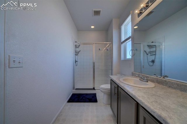 bathroom with tile patterned flooring, vanity, an enclosed shower, and toilet