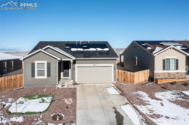 view of front of home featuring a garage and solar panels