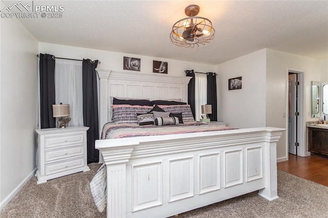 bedroom featuring dark carpet and baseboards