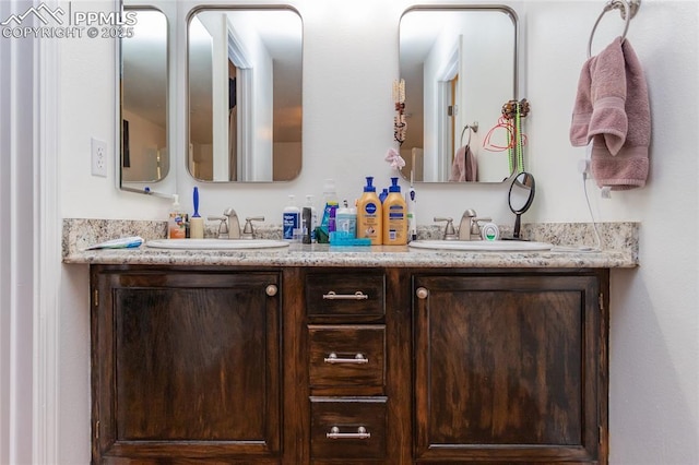 full bath with a sink and double vanity