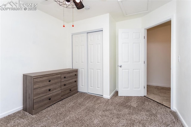 unfurnished bedroom featuring a closet, carpet, and baseboards