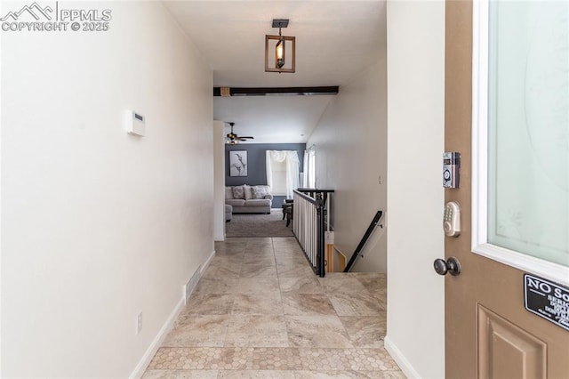 corridor with baseboards and an upstairs landing