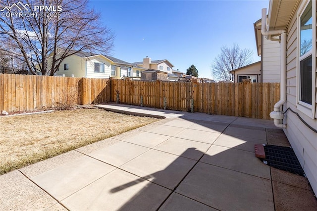 view of patio / terrace featuring a residential view and a fenced backyard