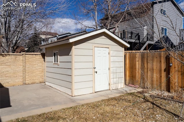 view of shed with fence