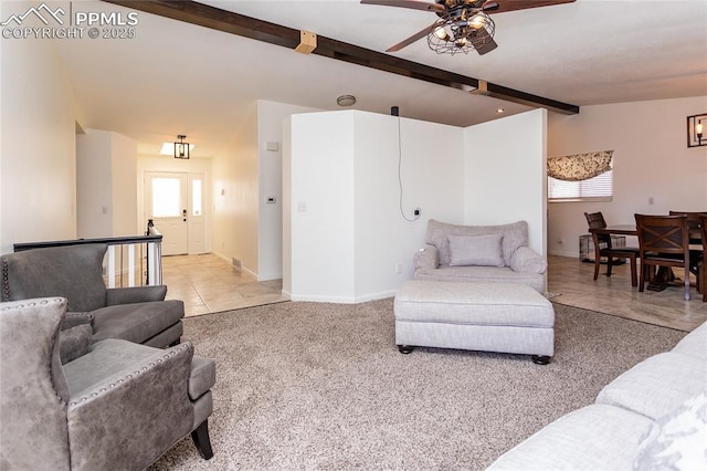 carpeted living room with vaulted ceiling with beams, tile patterned flooring, baseboards, and a ceiling fan