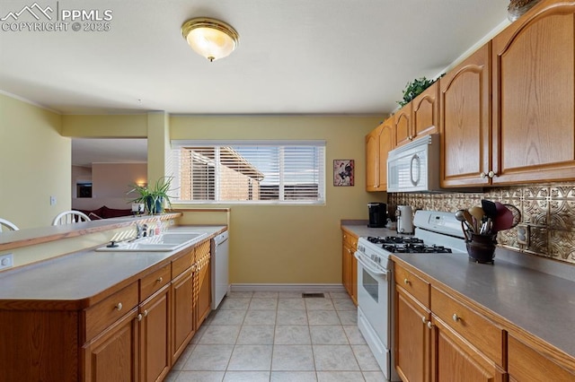 kitchen with backsplash, white appliances, sink, and light tile patterned flooring