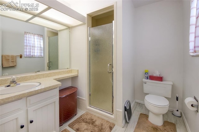 bathroom with walk in shower, vanity, and toilet