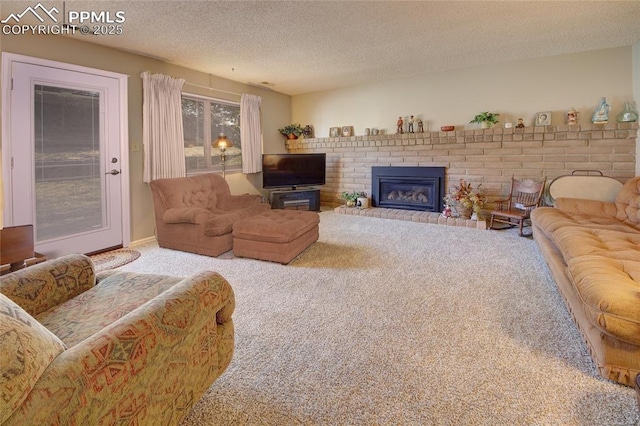 living room with carpet flooring, a fireplace, and a textured ceiling