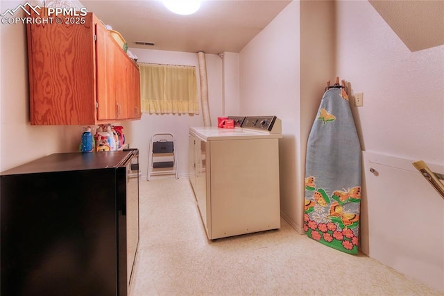 laundry room with cabinets and washer and dryer