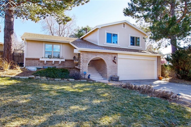 split level home with a garage and a front yard