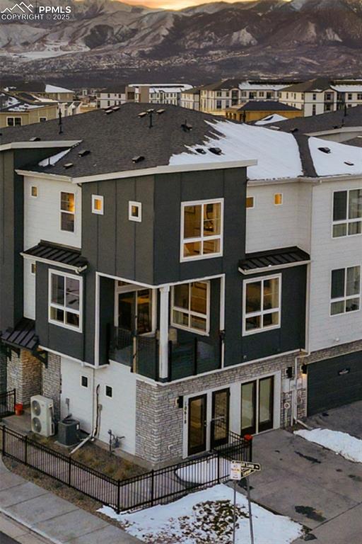 view of front of house with central AC unit and ac unit