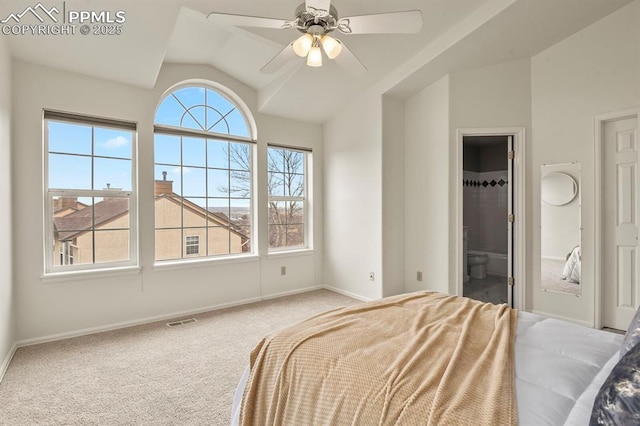 carpeted bedroom with ceiling fan, lofted ceiling, and connected bathroom