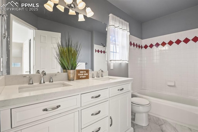 full bathroom featuring tiled shower / bath, vanity, toilet, and a chandelier