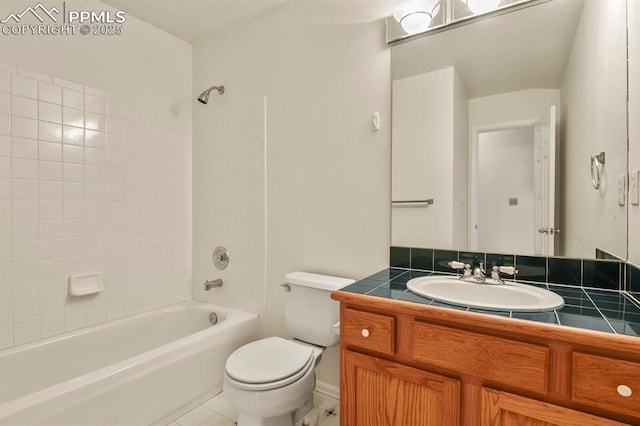 full bathroom featuring tiled shower / bath combo, vanity, tile patterned flooring, and toilet