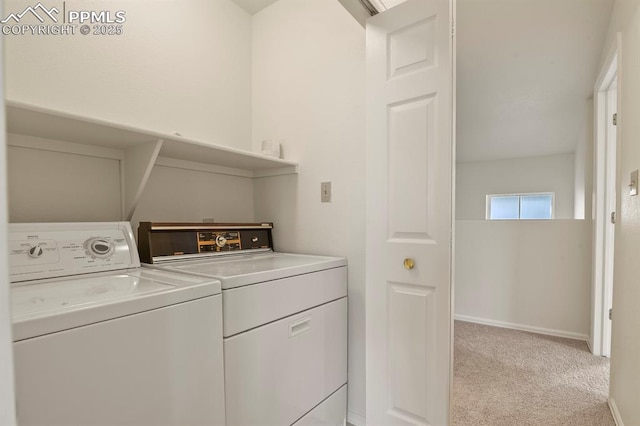 laundry area with separate washer and dryer and light colored carpet