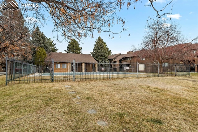 rear view of property featuring a lawn