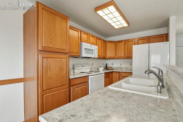 kitchen featuring sink and white appliances