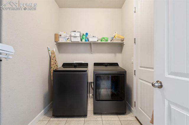 washroom with separate washer and dryer and light tile patterned floors