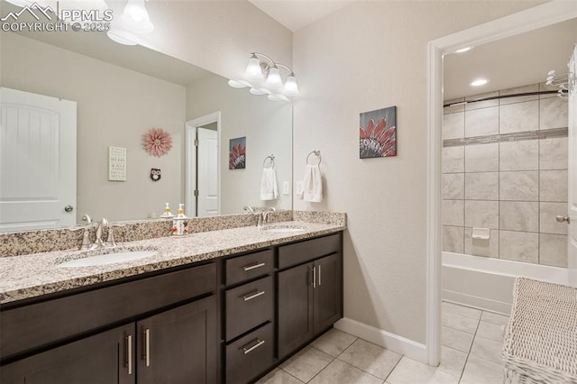 bathroom with tile patterned floors, tiled shower / bath combo, and vanity