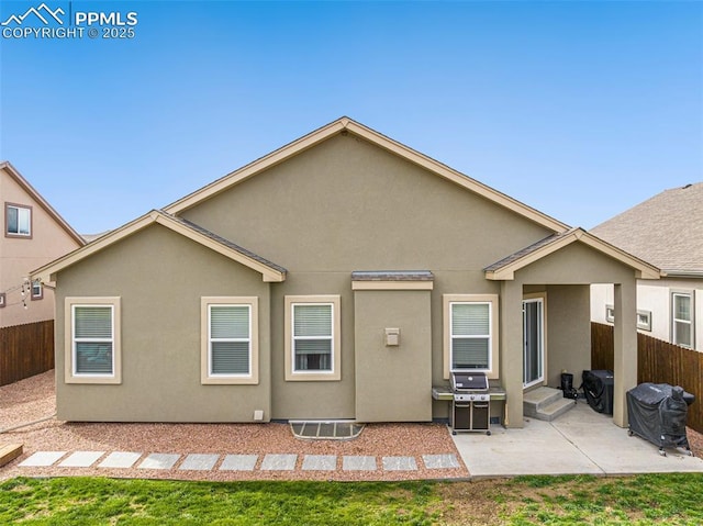 rear view of house with a patio and a yard