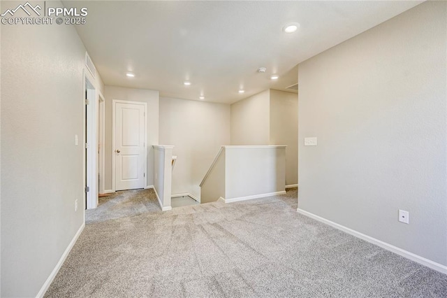 unfurnished room with light colored carpet