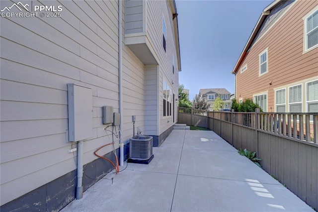 view of property exterior with a patio and central air condition unit