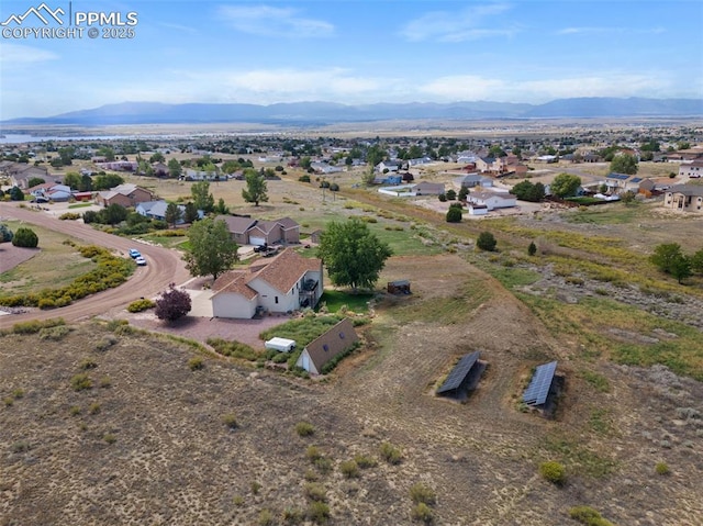 birds eye view of property with a mountain view