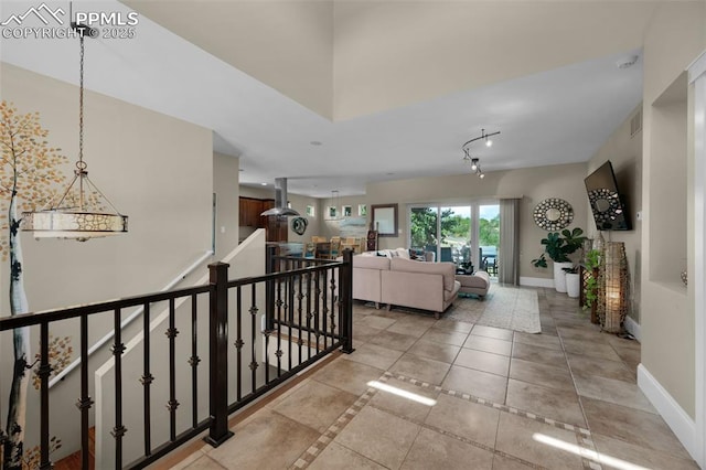 hall featuring light tile patterned flooring