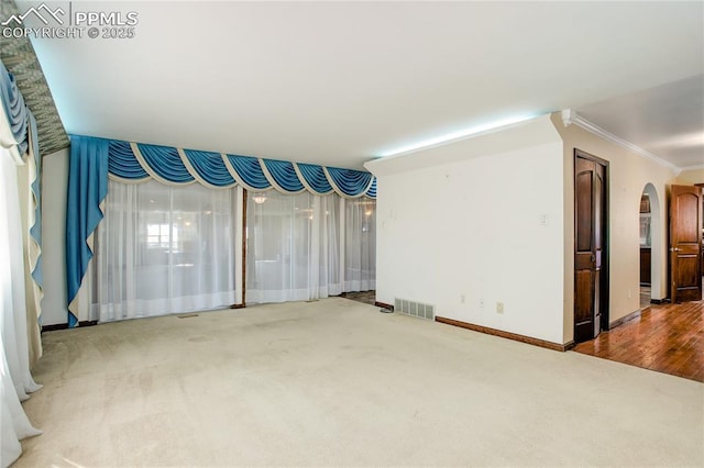 interior space featuring ornamental molding and carpet flooring