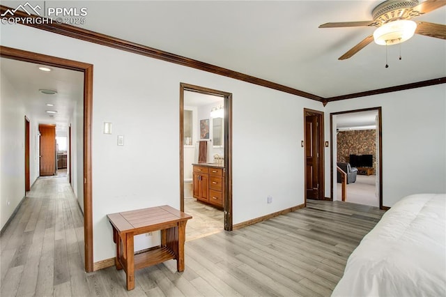 bedroom with ensuite bath, light hardwood / wood-style flooring, ornamental molding, and ceiling fan