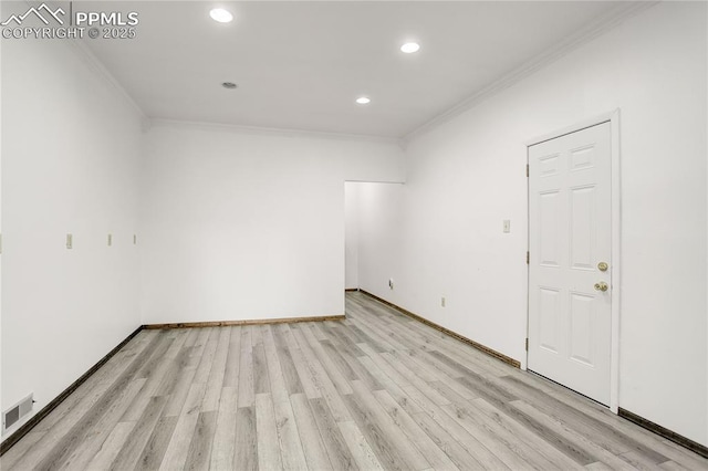 spare room with crown molding and light wood-type flooring