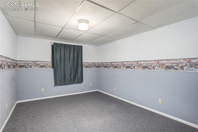 carpeted spare room featuring a paneled ceiling