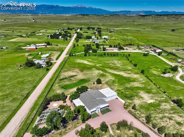 drone / aerial view with a mountain view and a rural view