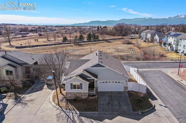 birds eye view of property with a mountain view