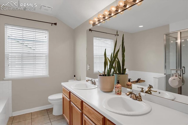 full bathroom featuring vanity, plus walk in shower, vaulted ceiling, tile patterned floors, and toilet