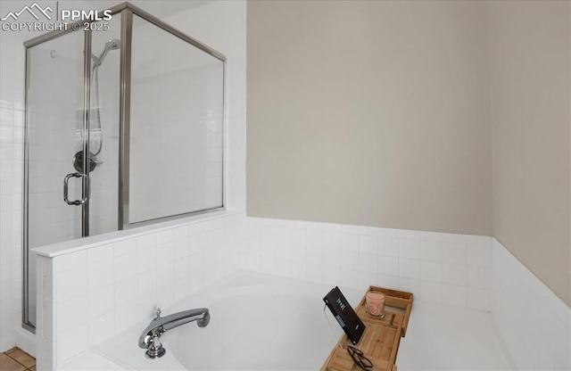 bathroom with separate shower and tub