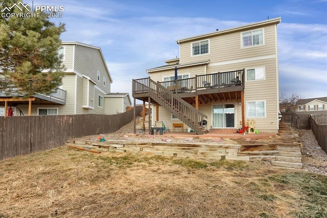 rear view of house featuring a deck