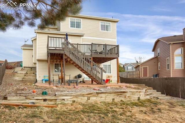 rear view of house featuring a wooden deck