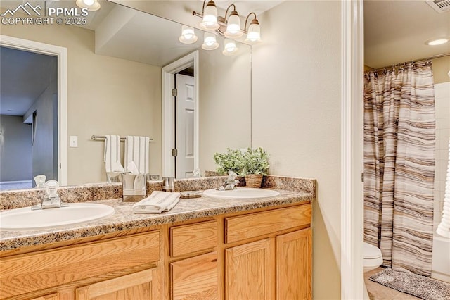 bathroom featuring vanity and toilet