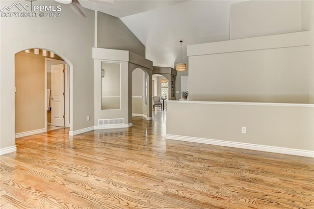 unfurnished living room featuring light hardwood / wood-style flooring, high vaulted ceiling, and ceiling fan