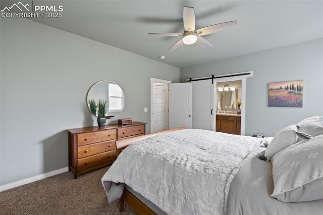 bedroom with a barn door, baseboards, connected bathroom, a ceiling fan, and carpet