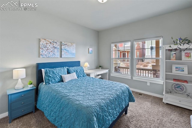 bedroom featuring carpet and baseboards