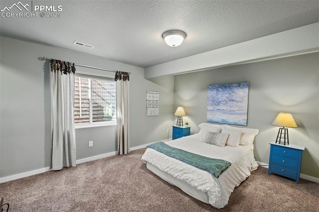 bedroom with carpet floors, visible vents, baseboards, and a textured ceiling