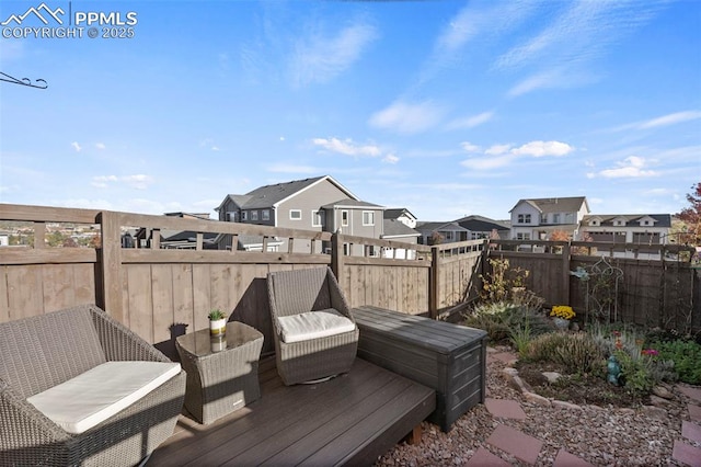 wooden terrace with a residential view and fence