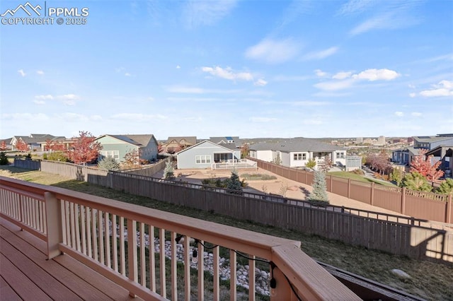 wooden deck with a fenced backyard and a residential view