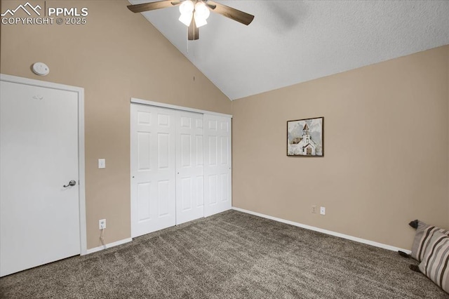 unfurnished bedroom with high vaulted ceiling, a closet, ceiling fan, and carpet flooring