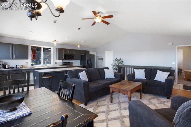 living area featuring a ceiling fan and lofted ceiling