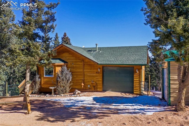 view of front of home with an attached garage, driveway, and roof with shingles