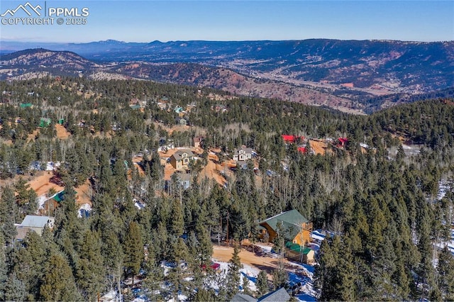 aerial view featuring a forest view and a mountain view